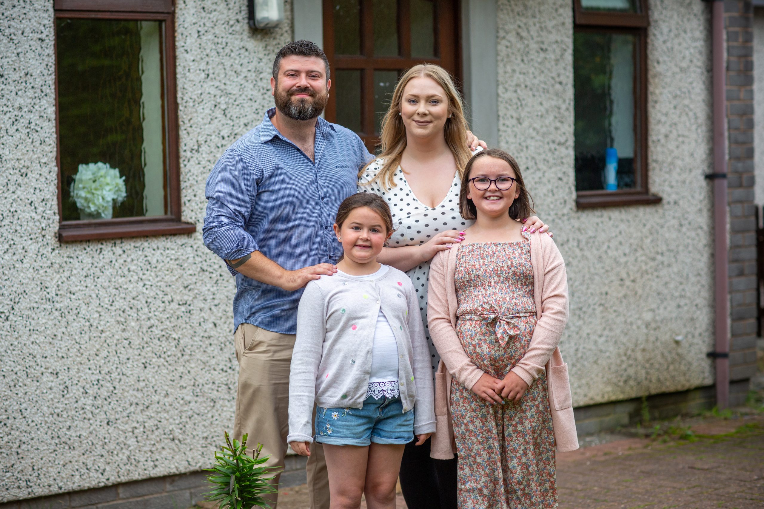 A family in front of the house