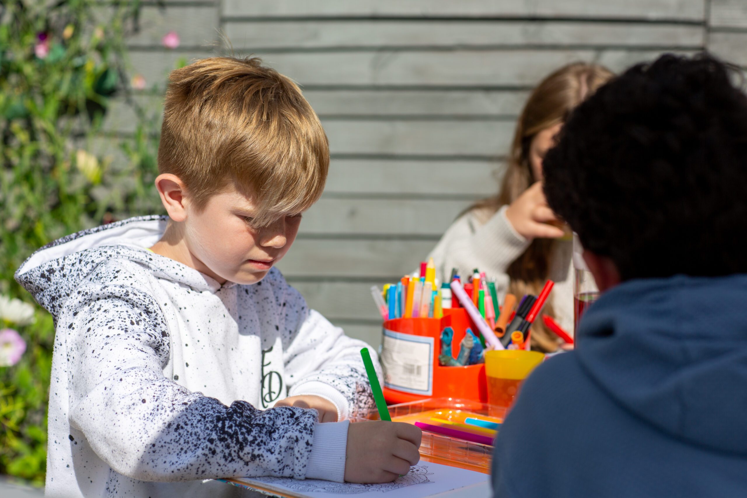 Boy colouring outside