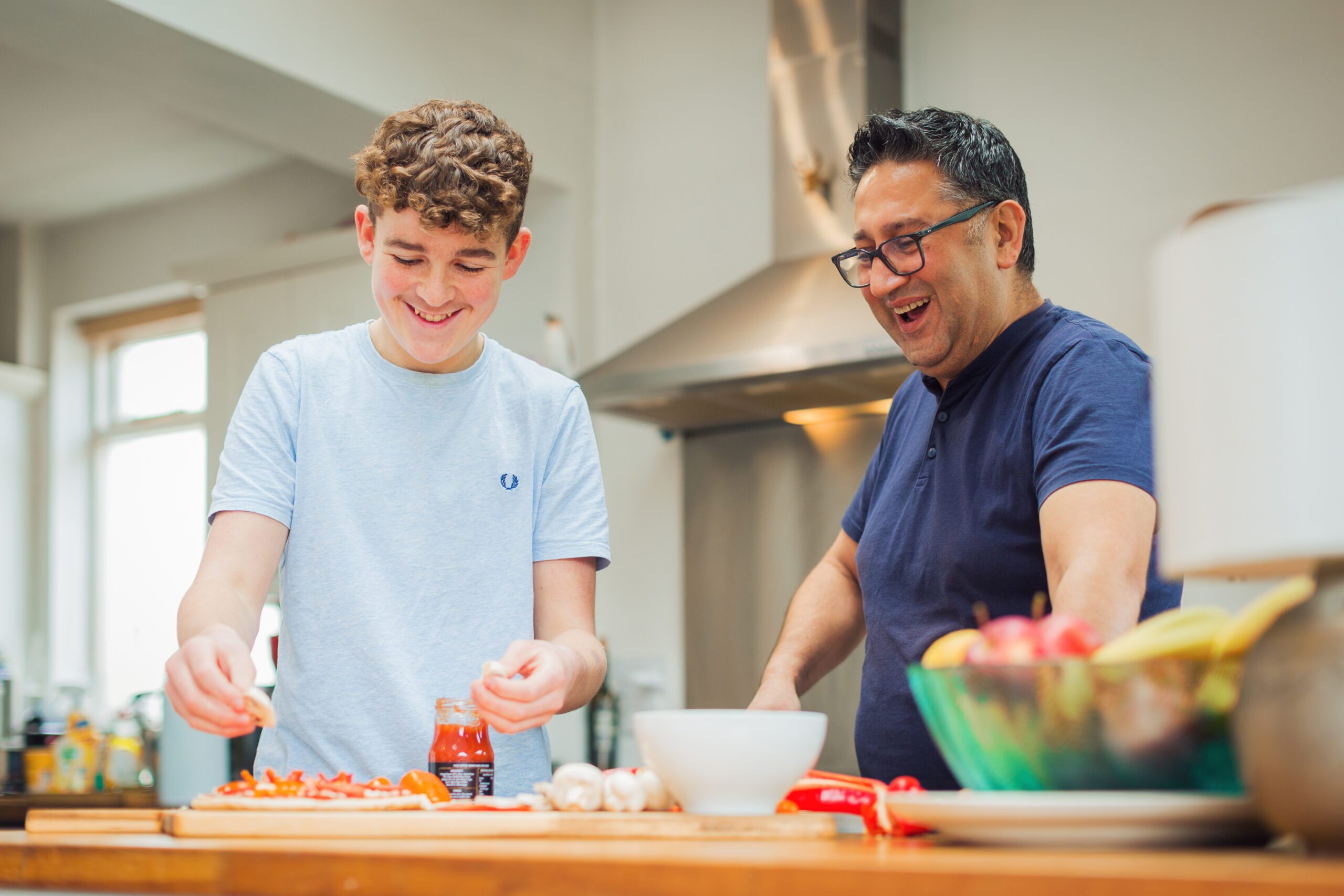 Man and teenage boy in kitchen